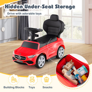 Red toy car with hidden under-seat storage filled with toys and snacks in a room.