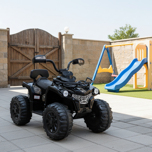Black toy ATV on a patio with playground equipment in the background