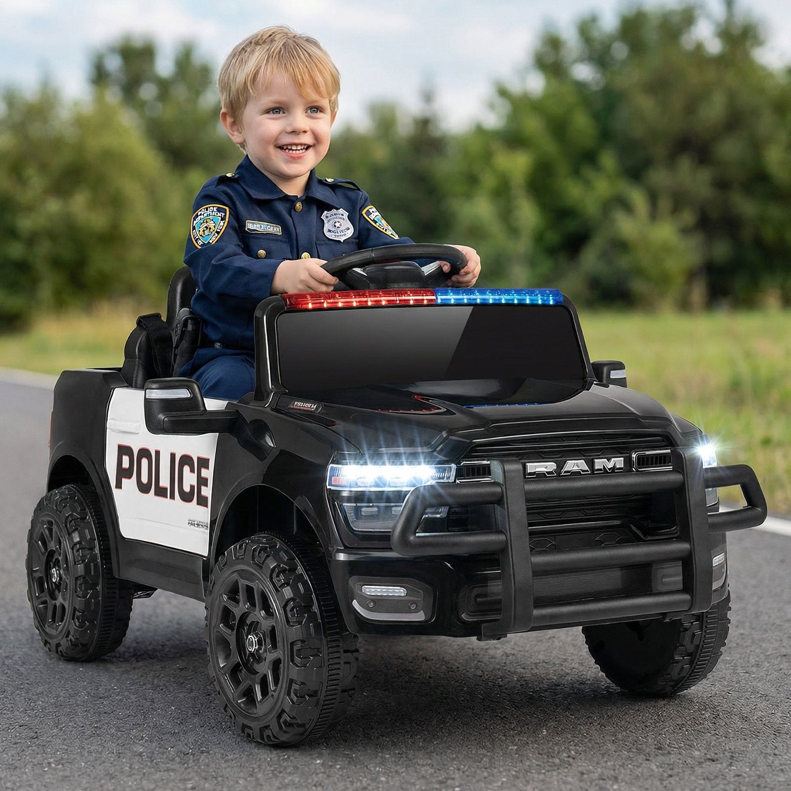 Child in a toy police car with a police uniform on a road.