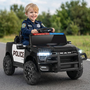 Child in a toy police car with a police uniform on a road.