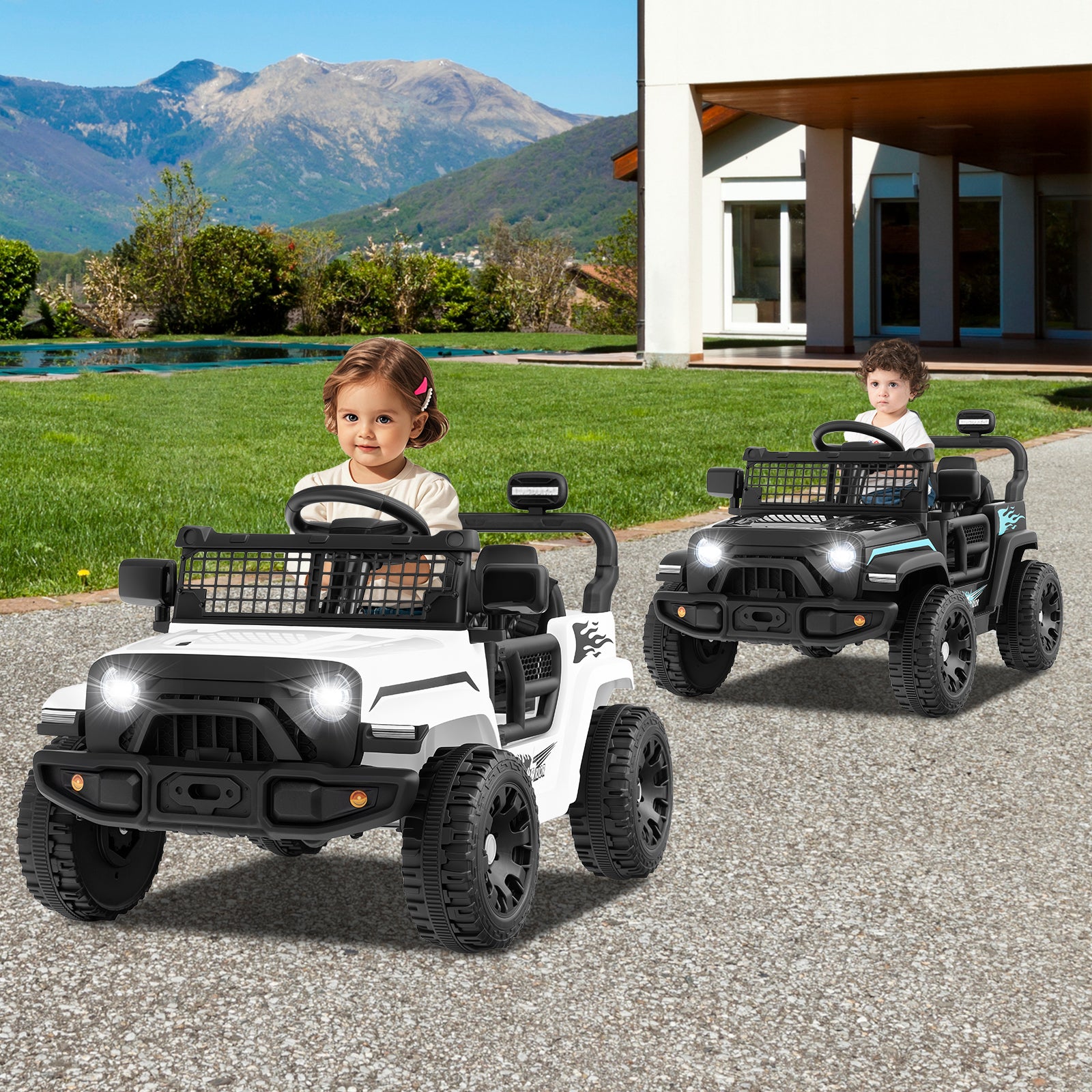Two children playing with toy cars on a driveway with mountains in the background