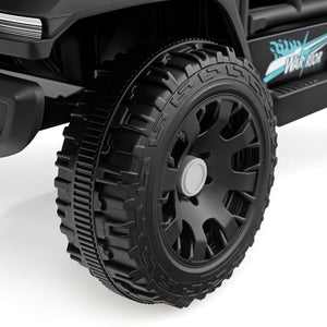 Close-up of a black off-road vehicle tire with detailed tread pattern on a white background