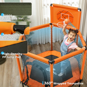 Child playing with a trampoline featuring basketball hoop and protective net in a home setting.