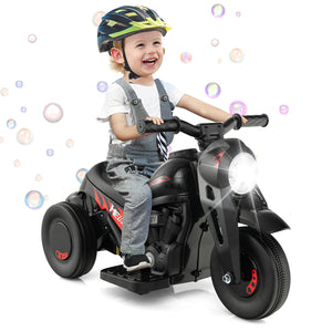 Child riding a toy motorcycle with bubbles in the background