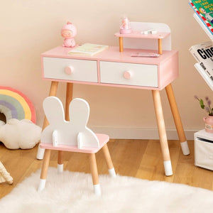 Pink children's desk with two drawers and a matching chair in a room setting.
