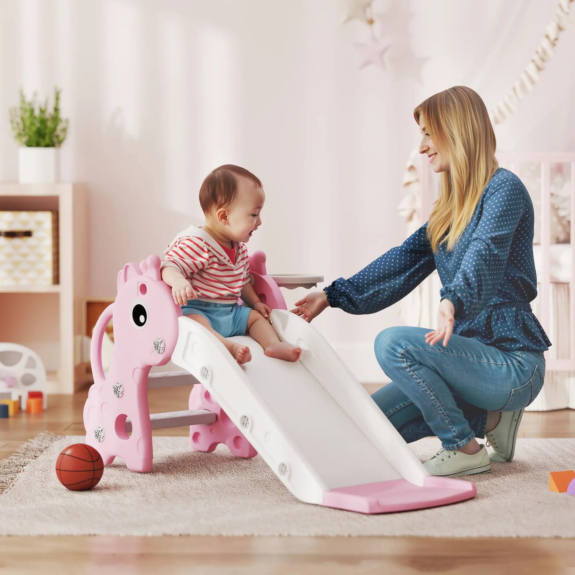 Woman and child playing on a pink and white slide in a home setting