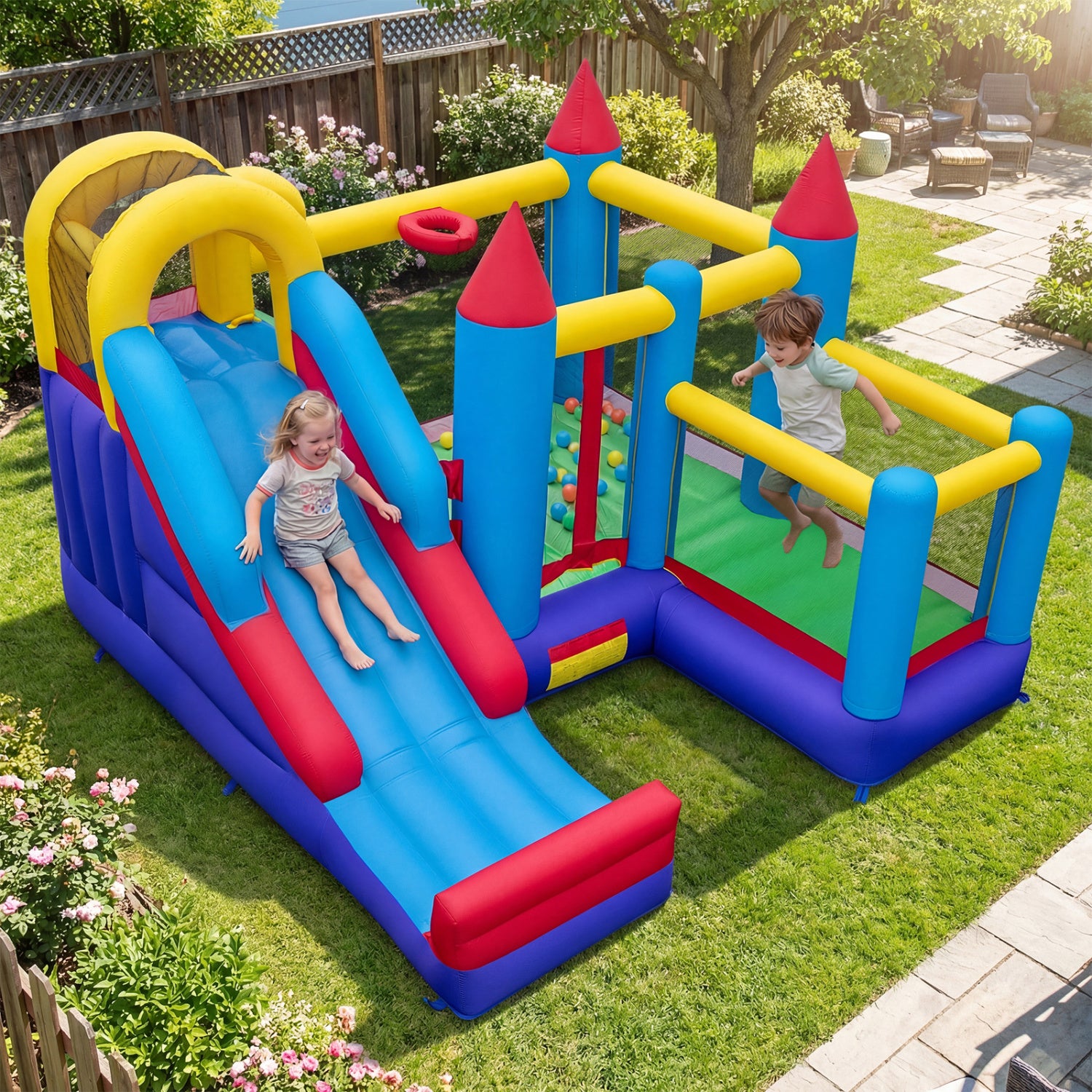 Children playing on a colorful inflatable playground set in a backyard.