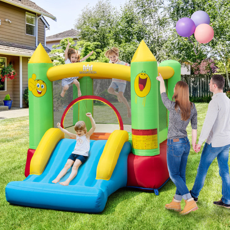 Smiley face inflatable bounce house with slide in backyard
