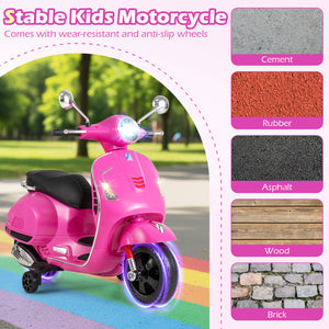 Pink kids' motorcycle with wear-resistant and anti-slip wheels on a colorful path, surrounded by pavement and grass.
