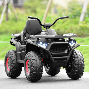 Black toy ATV with red rims on a road with greenery in the background
