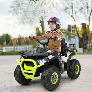 Child riding a toy ATV on a paved path with trees in the background