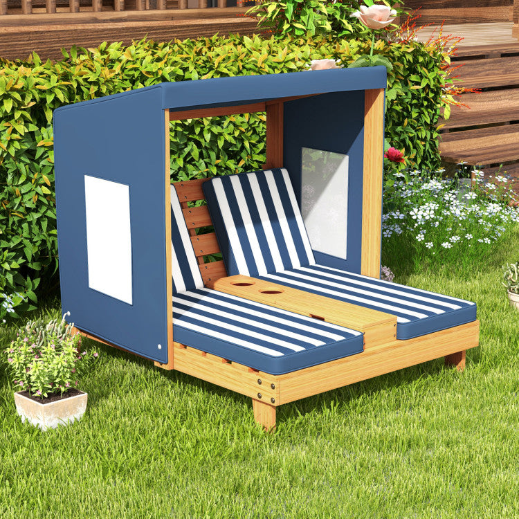 Wooden outdoor lounge chair with striped cushions in a garden setting