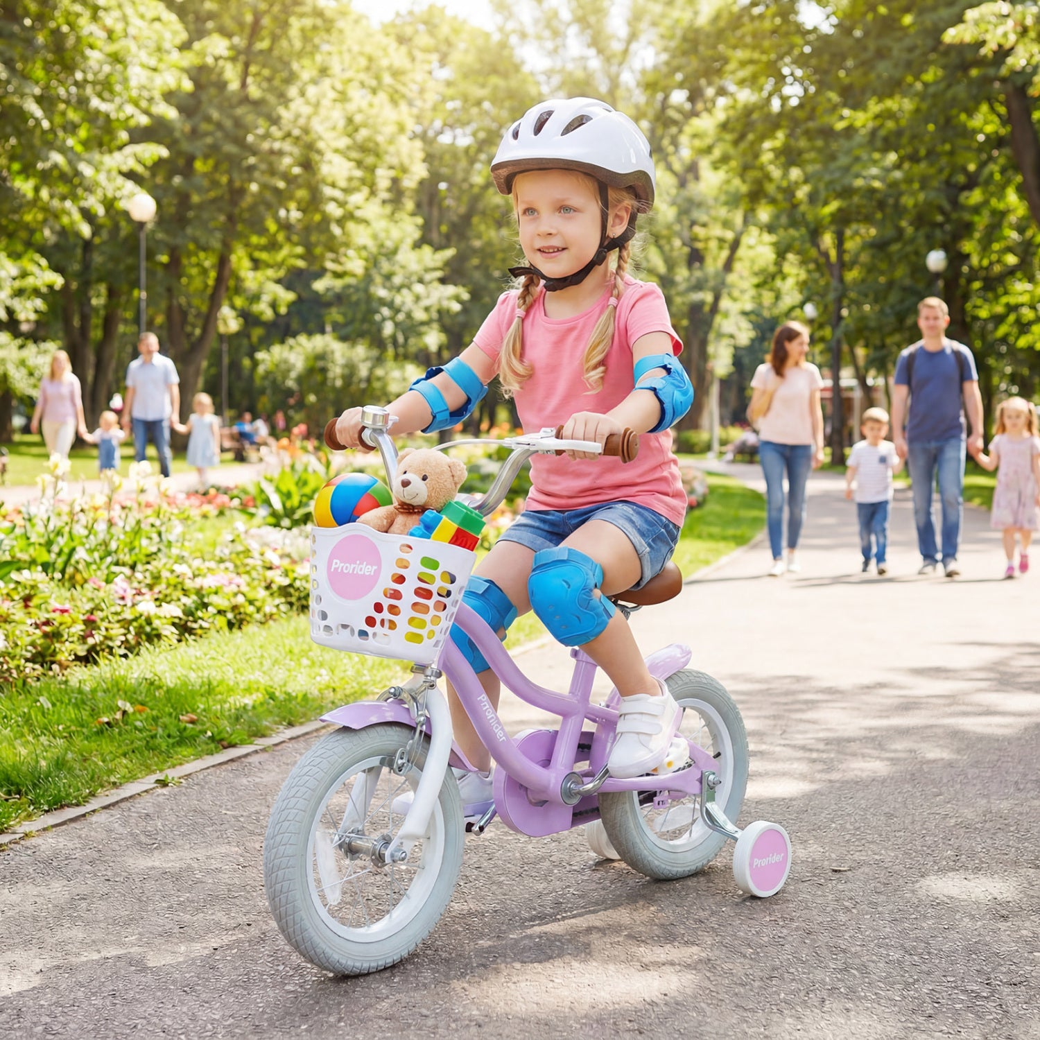 Child riding a bicycle with training wheels in a park, wearing a helmet and protective gear.