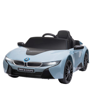 Kids BMW I8 electric ride-on car being driven outdoors.