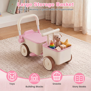 Pink and beige storage basket with wheels filled with toys on a wooden floor.