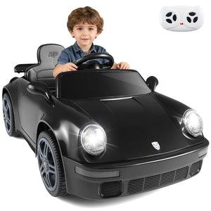 Child sitting in a toy car with a remote control on a white background