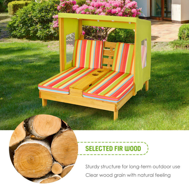 Children's playhouse with colorful cushions on a grassy area, featuring selected fir wood.