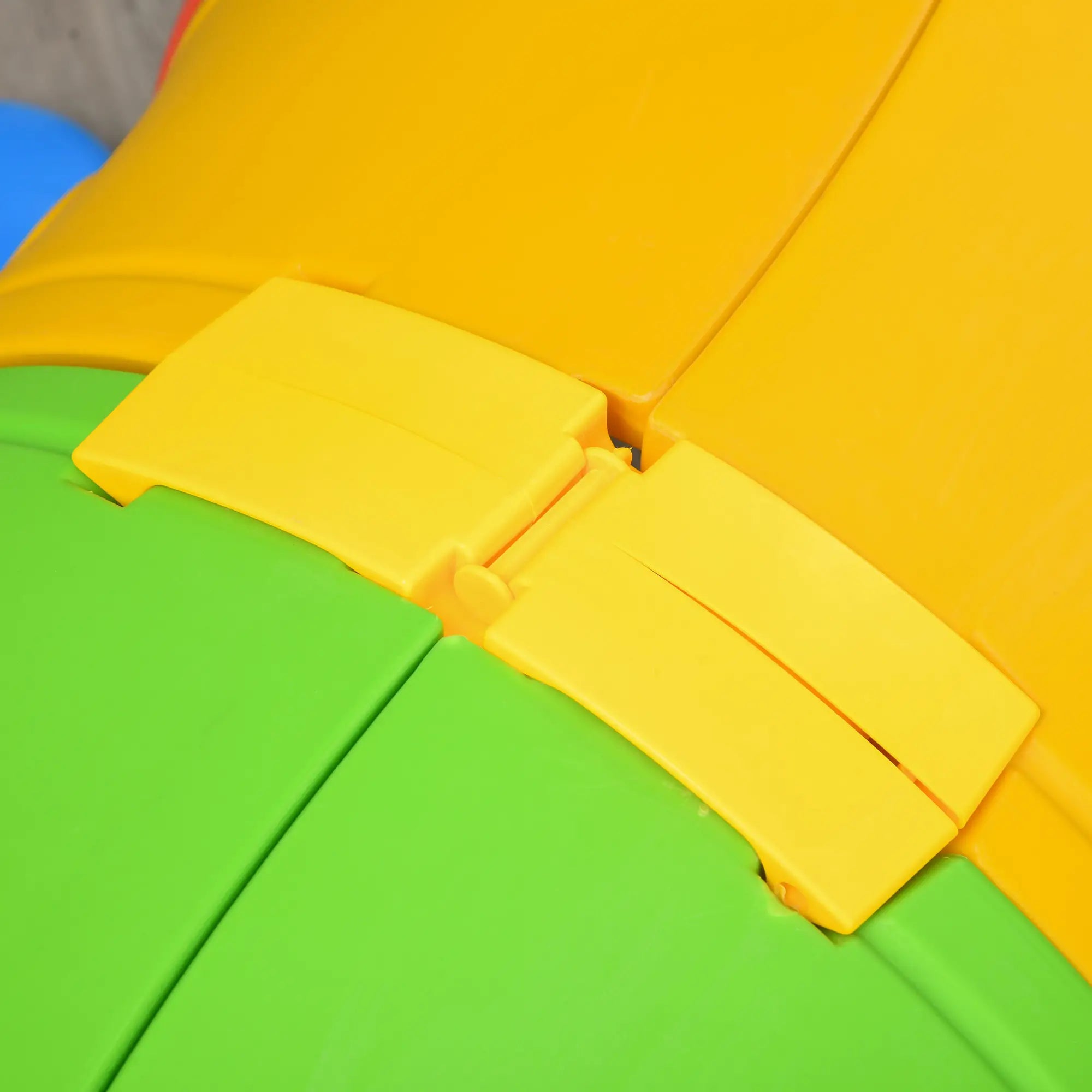 Close-up of a colorful plastic toy with yellow and green sections.