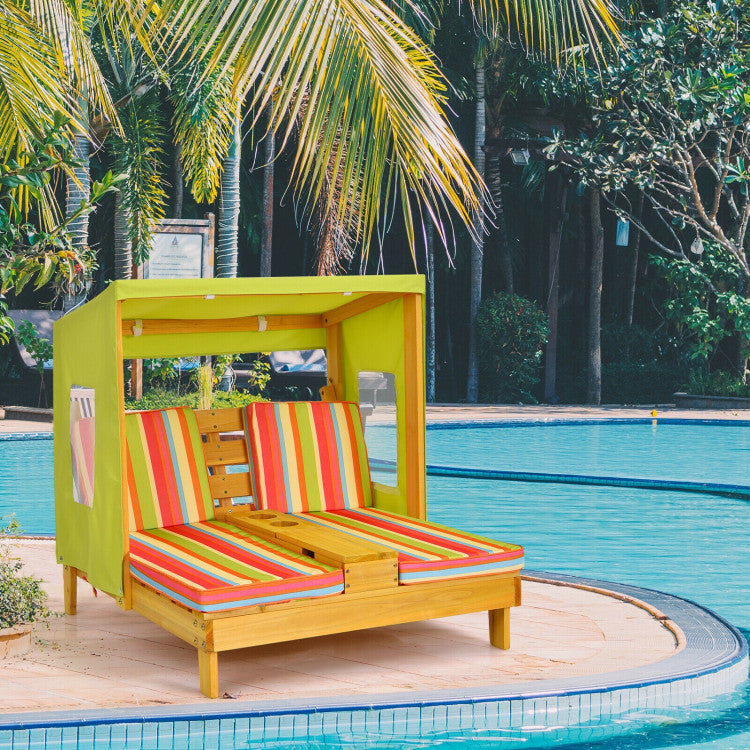 Colorful striped lounge chair with canopy by a poolside