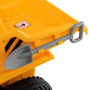 Yellow toy dump truck with a gray shovel on a white background