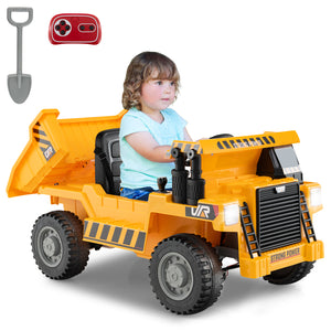 Child playing with a toy dump truck on a white background