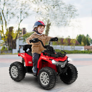 Child riding a red toy ATV on a paved path with trees and houses in the background