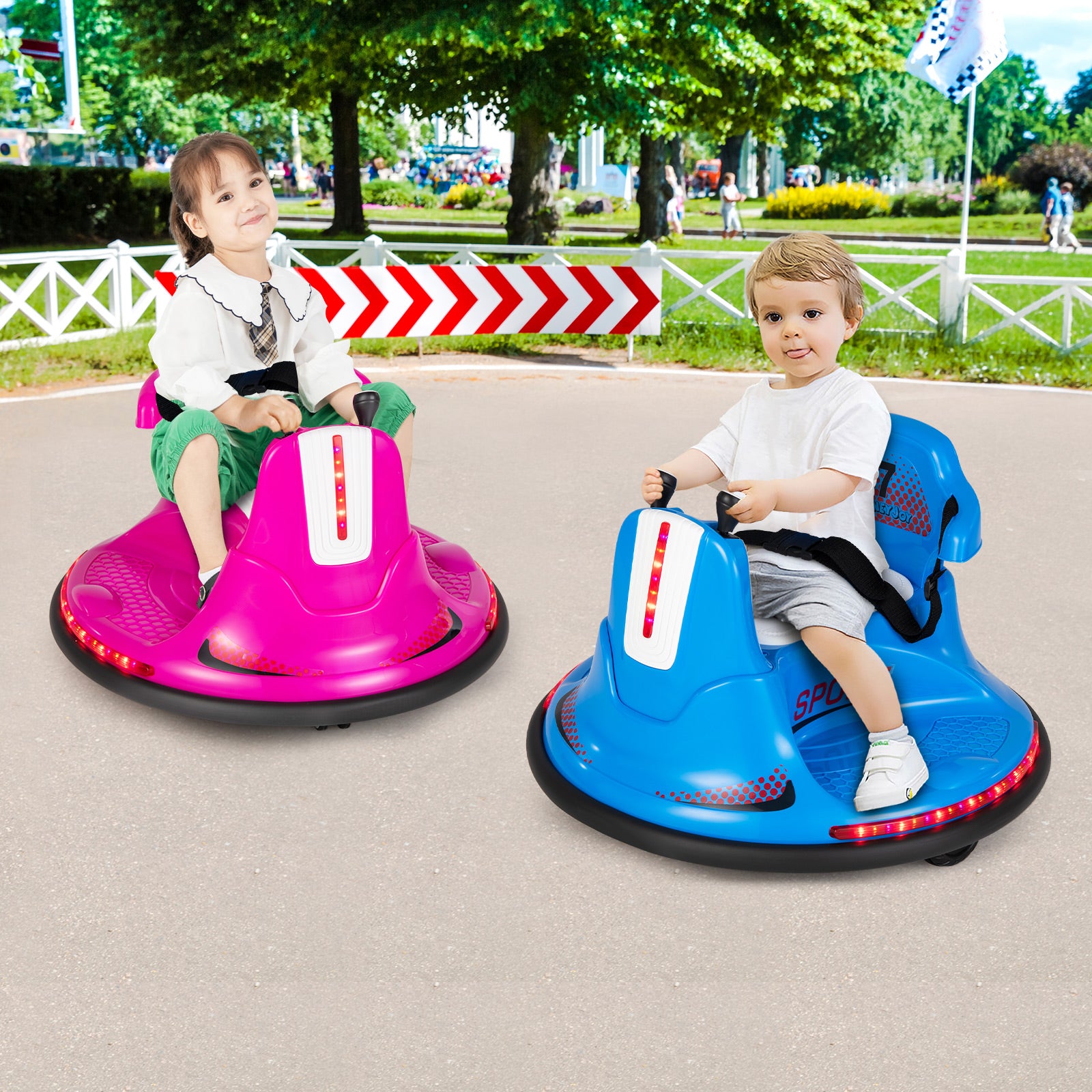Two children playing in bumper cars on a sunny day in an outdoor park.