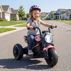 Child riding a pink toy motorcycle on a suburban street