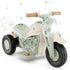 Children's toy motorcycle with a light green and beige design on a white background