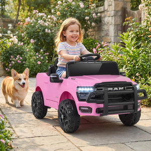 Child driving a pink toy truck with a dog standing nearby in a garden setting