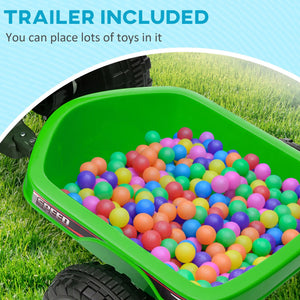 Green toy trailer filled with colorful balls on grass
