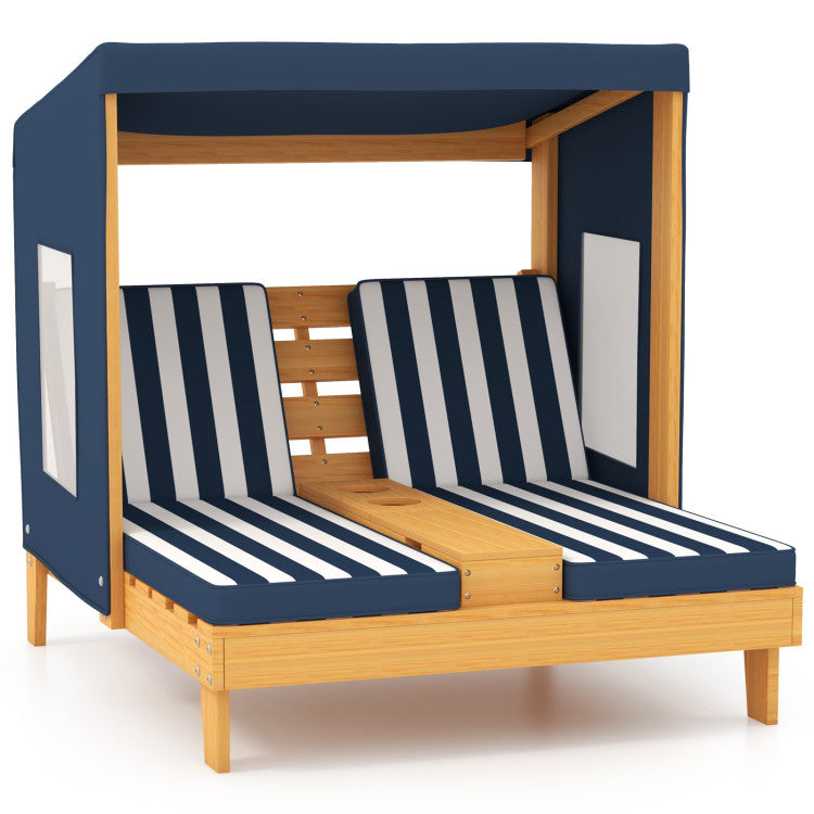 Wooden children's bed with navy and white striped mattress and canopy on a white background
