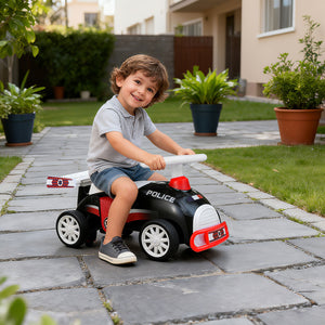 Child playing with a toy police car on a patio