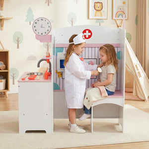 Two children playing with a toy doctor's office in a child-friendly room.