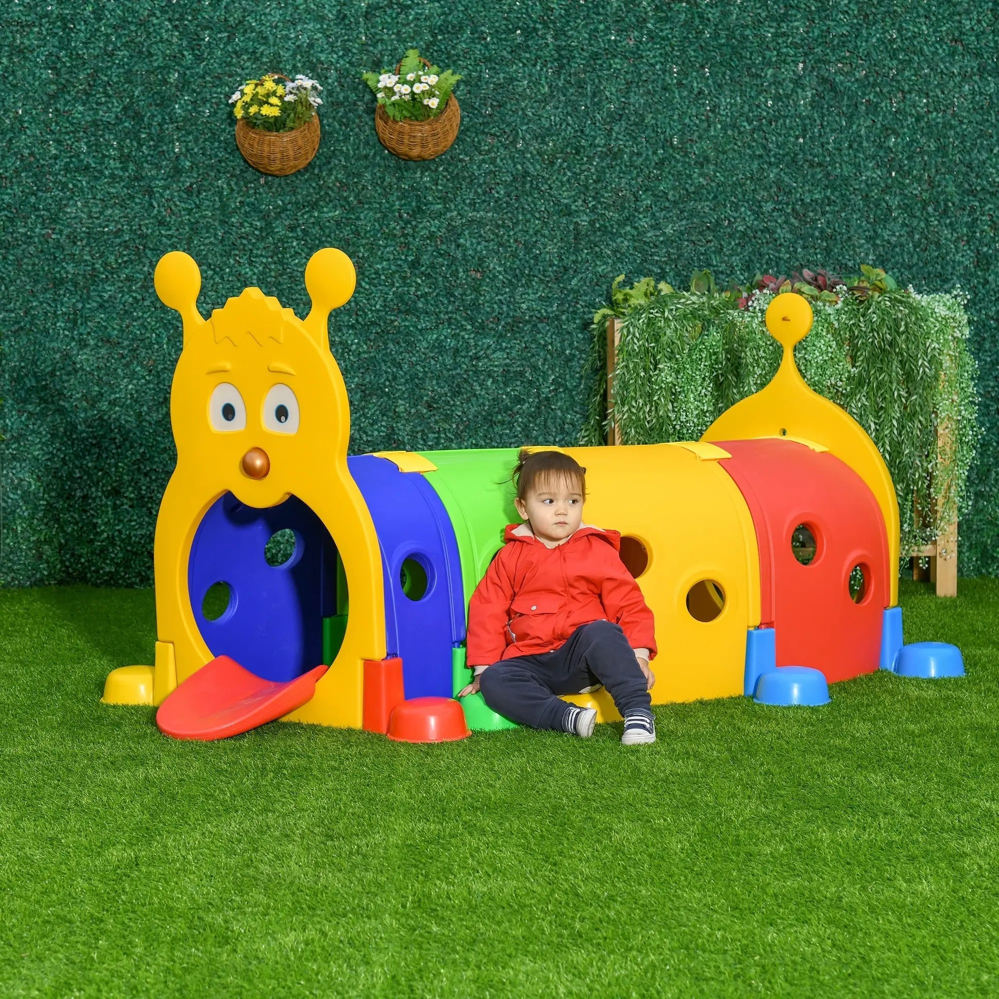 Child sitting on a colorful play structure with a green background