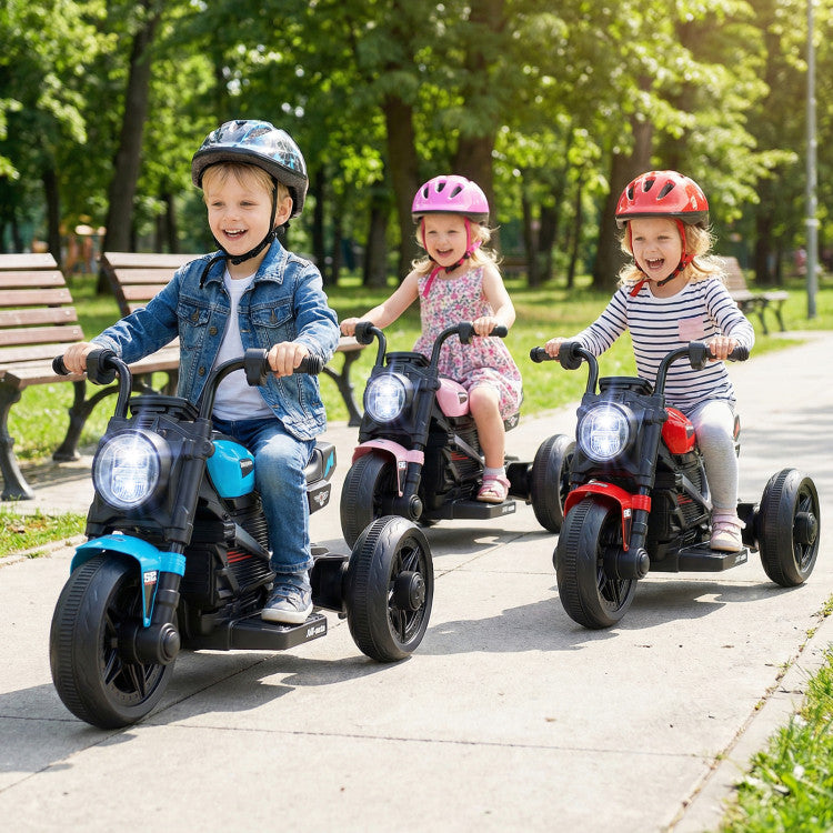 Three children riding toy motorcycles on a path in a park.
