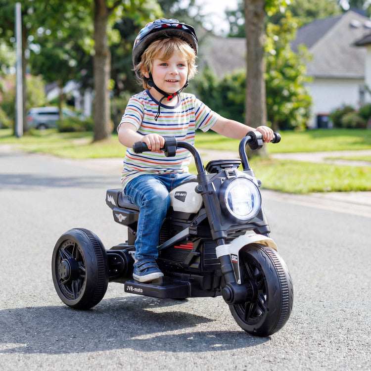 Child riding a toy motorcycle on a suburban street