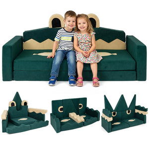 Children sitting on a green dinosaur-shaped sofa with detachable parts displayed below.