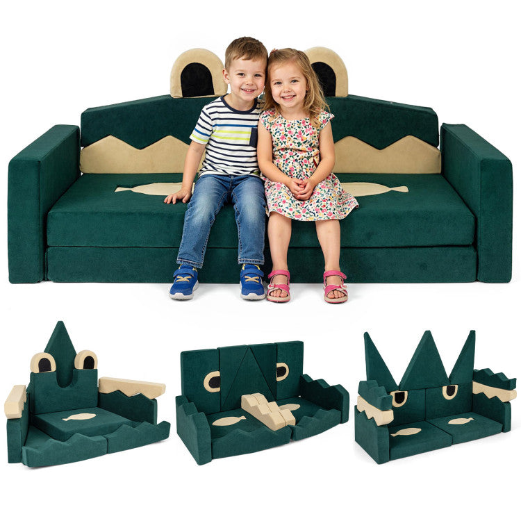 Children sitting on a green dinosaur-shaped sofa with detachable parts displayed below.