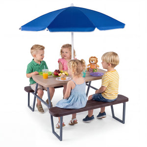 Children sitting at a table with a blue umbrella on a white background