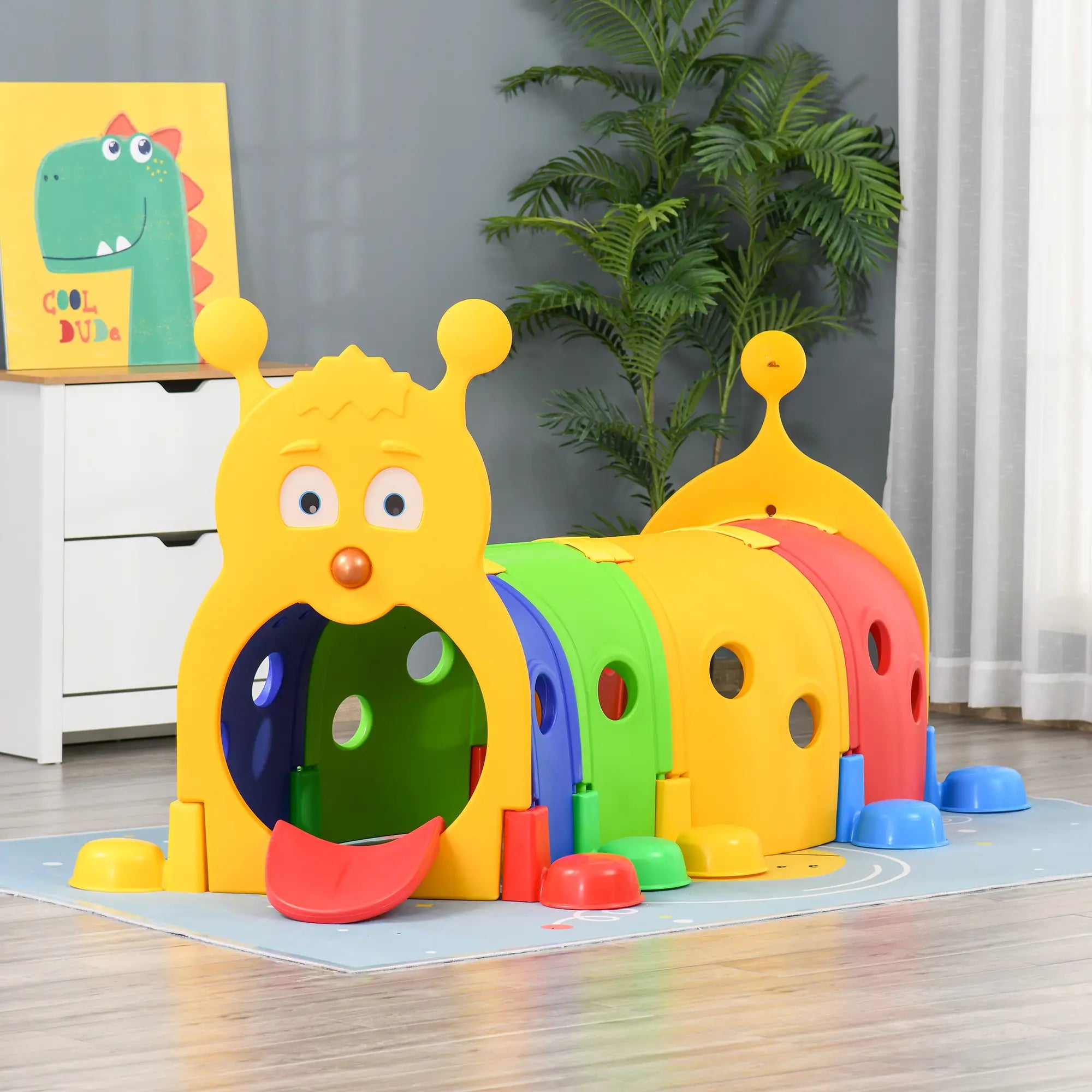 Colorful children's play structure with cartoon face on a wooden floor.