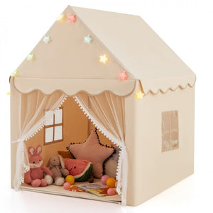 Children's playhouse with toys and decorative lights on a white background