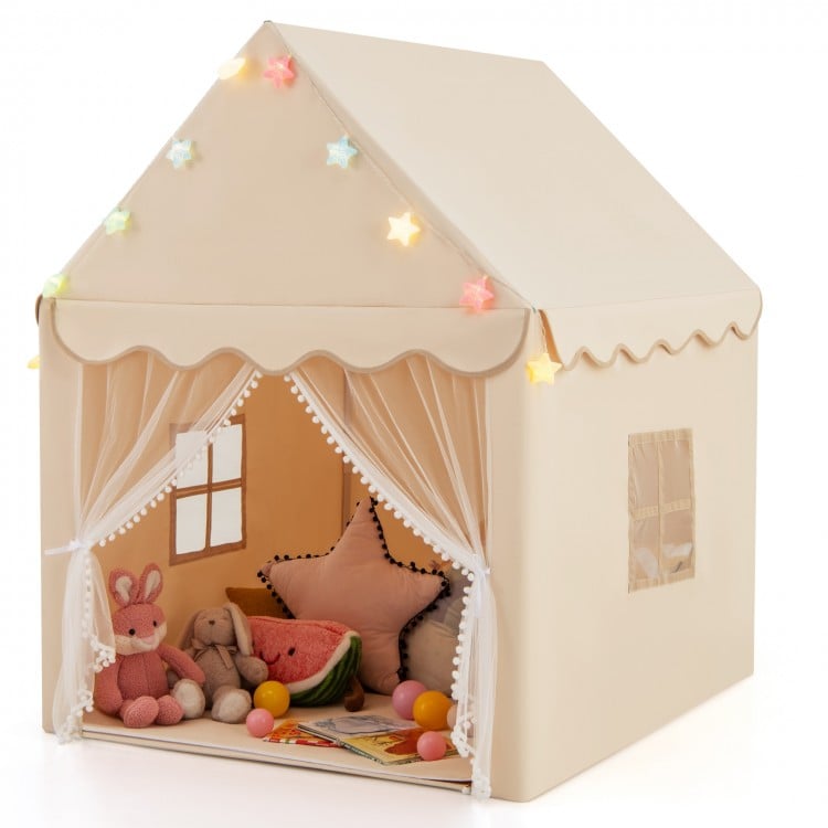 Children's playhouse with toys and decorative lights on a white background