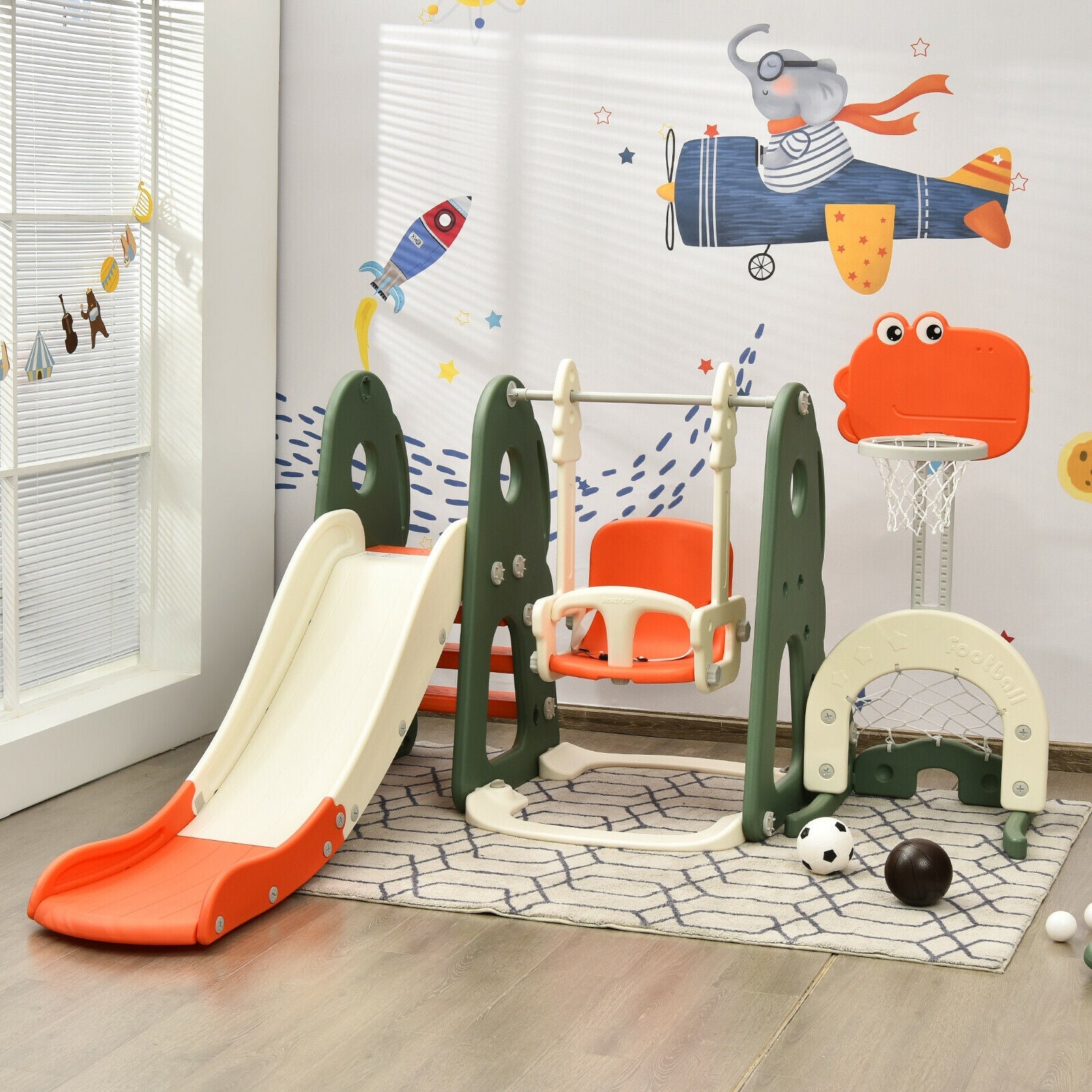Children's playset with slide, swing, and climbing structure in a room with colorful wall art.