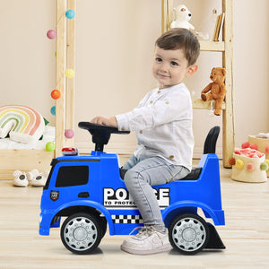 Child sitting on a blue toy police car in a room with toys and decorations.