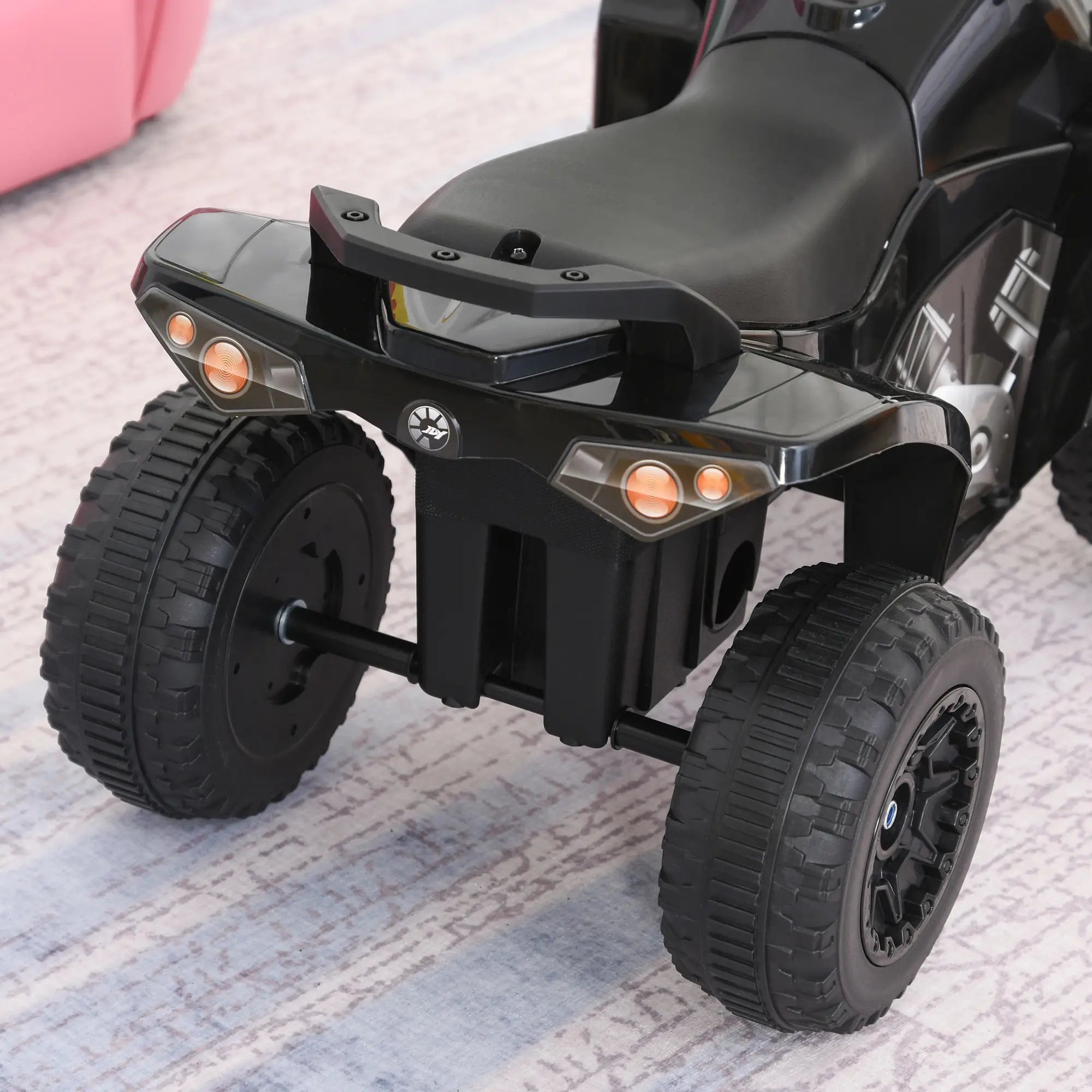 Black toy ATV on a carpeted floor