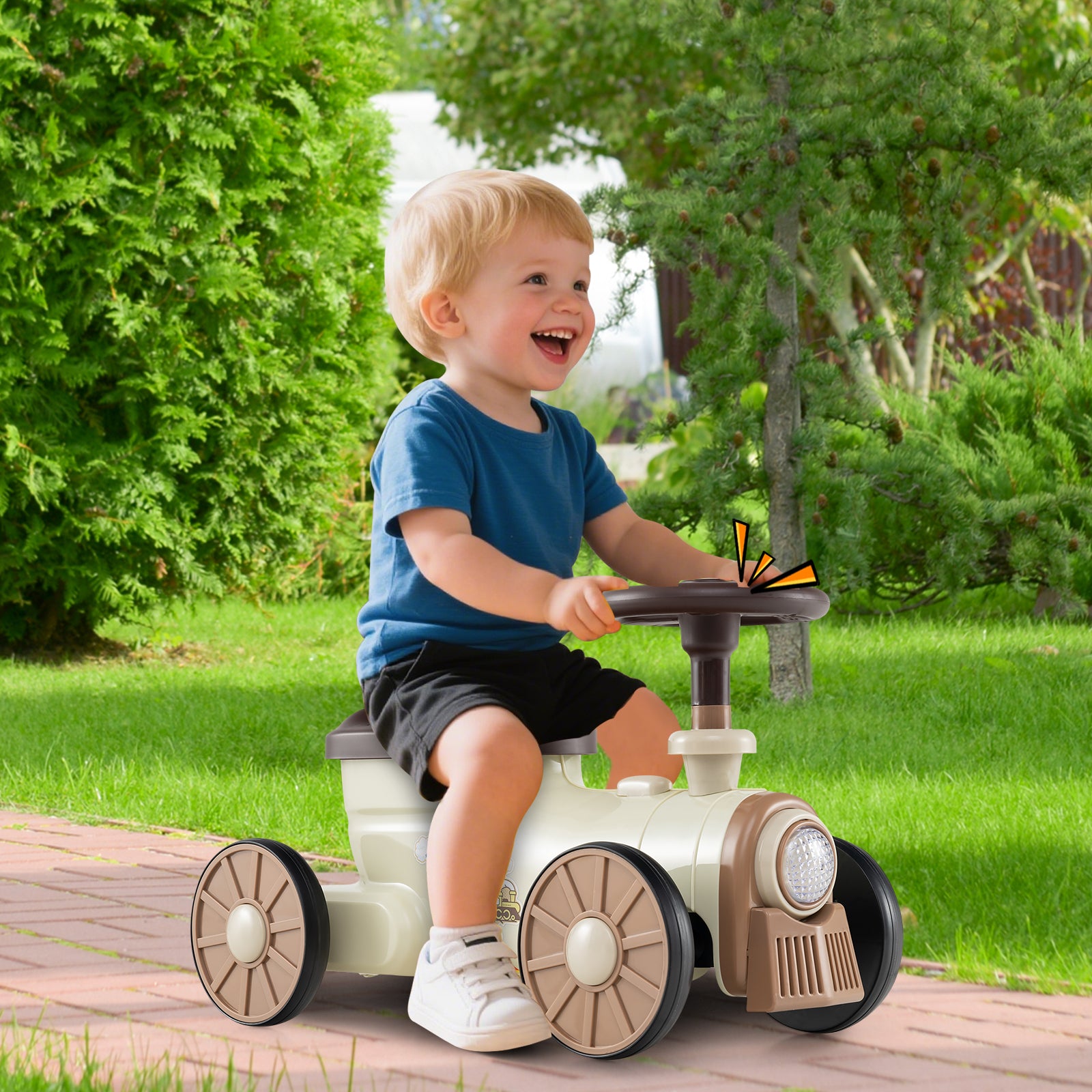 Child sitting on a toy tractor in a park