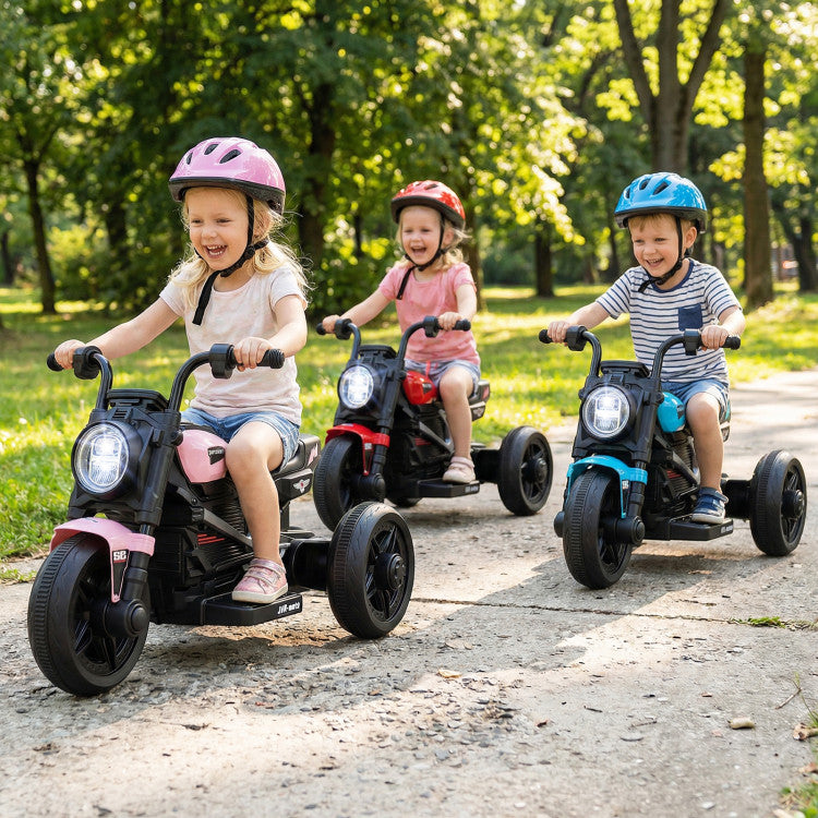 Three children riding toy motorcycles in a park