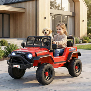 Child sitting in a red toy jeep with a dog, outside a modern house.