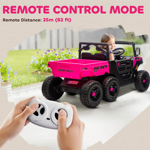 Pink and black toy truck with remote control in front, child inside, outdoor setting